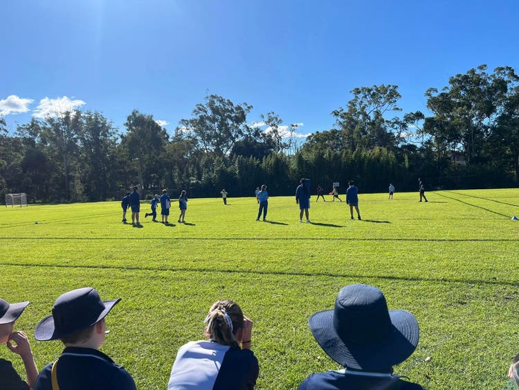 May be an image of 15 people, people playing soccer and grass